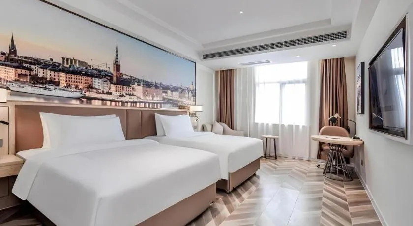 Bed in Vienna Hotel Sichuan Hejiang Yangtze River Bridge