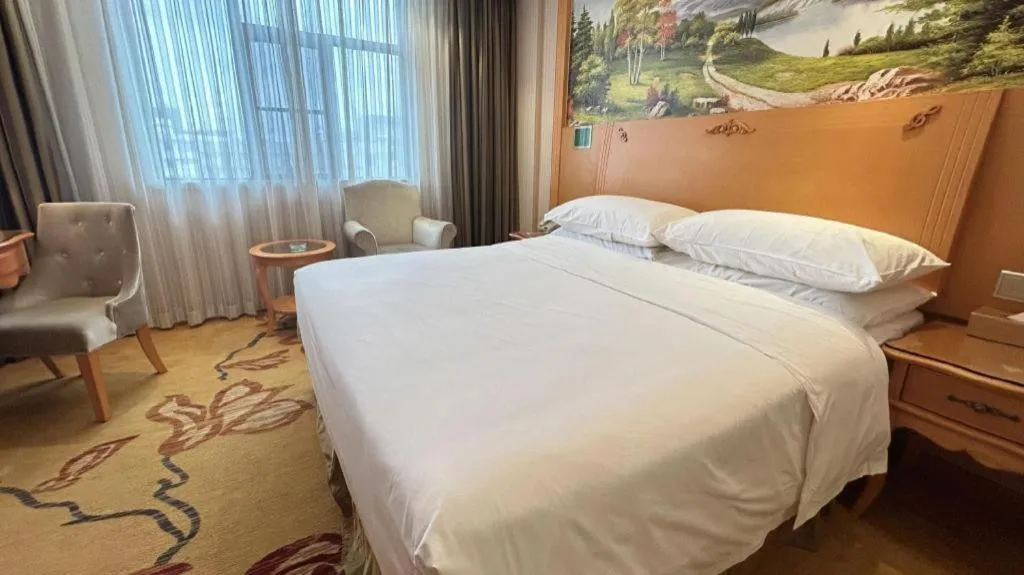 Bed in Vienna Hotel Guangxi Beiliu Passenger Station