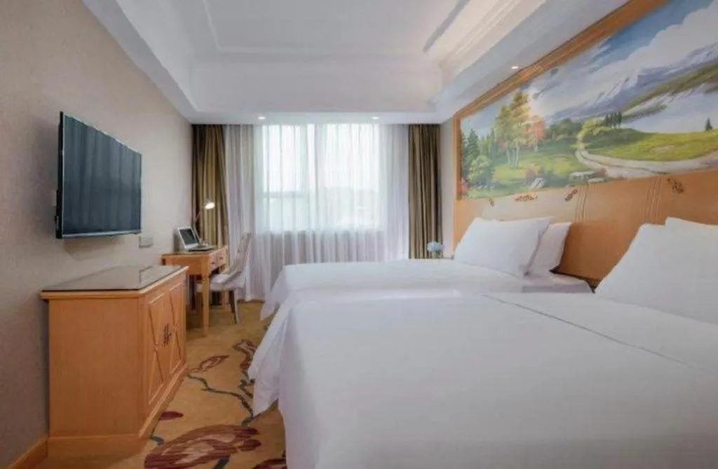 Bed in Vienna Hotel Guangxi Beiliu Passenger Station