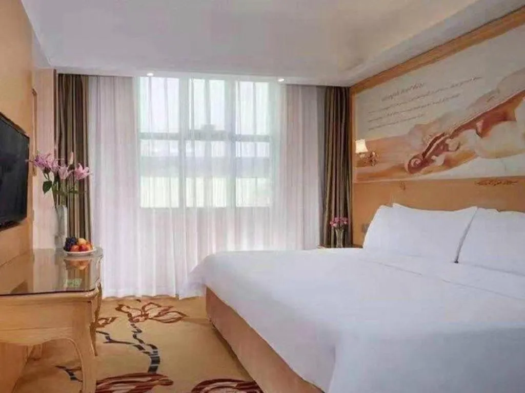 Bed in Vienna Hotel Guangxi Beiliu Passenger Station