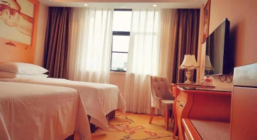 Bed in Vienna Hotel Guangxi Beiliu Passenger Station