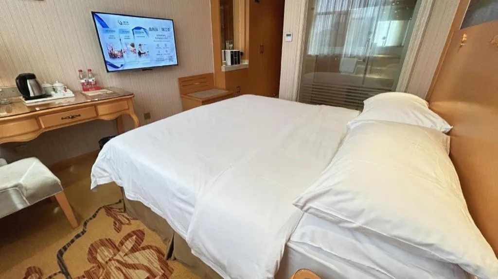 Bed in Vienna Hotel Guangxi Beiliu Passenger Station