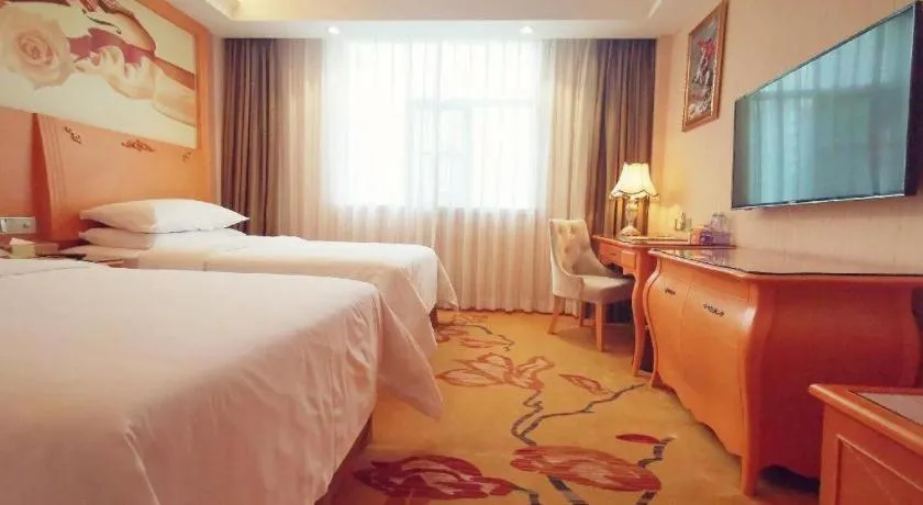 Bed in Vienna Hotel Guangxi Beiliu Passenger Station