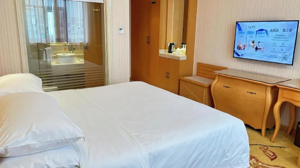 Bed in Vienna Hotel Guangxi Beiliu Passenger Station