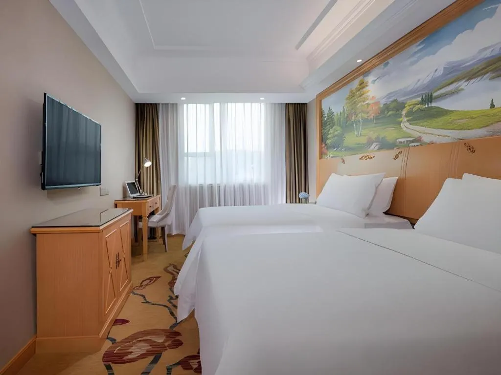 Bed in Vienna Hotel Guangxi Beiliu Passenger Station