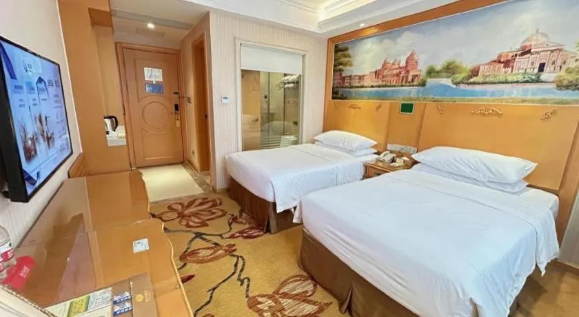 Bed in Vienna Hotel Guangxi Beiliu Passenger Station