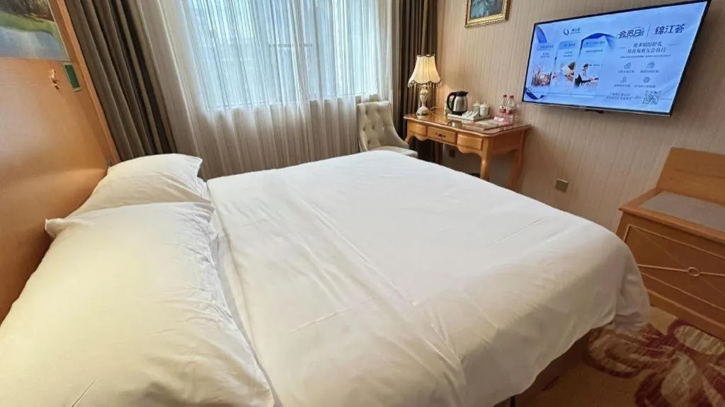 Bed in Vienna Hotel Guangxi Beiliu Passenger Station