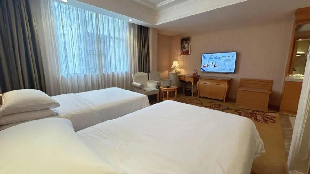 Bed in Vienna Hotel Guangxi Beiliu Passenger Station