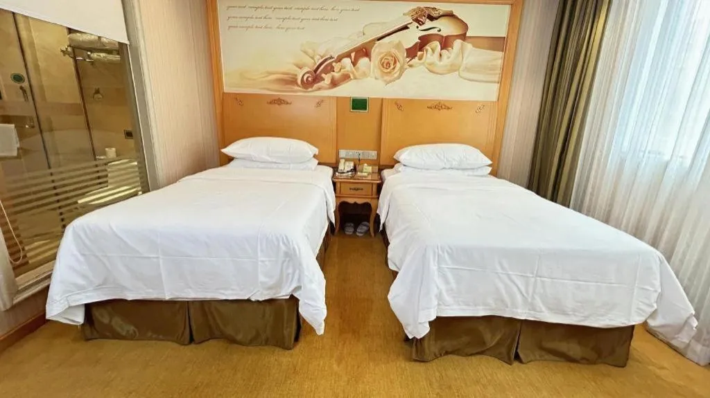 Bed in Vienna Hotel Guangxi Beiliu Passenger Station