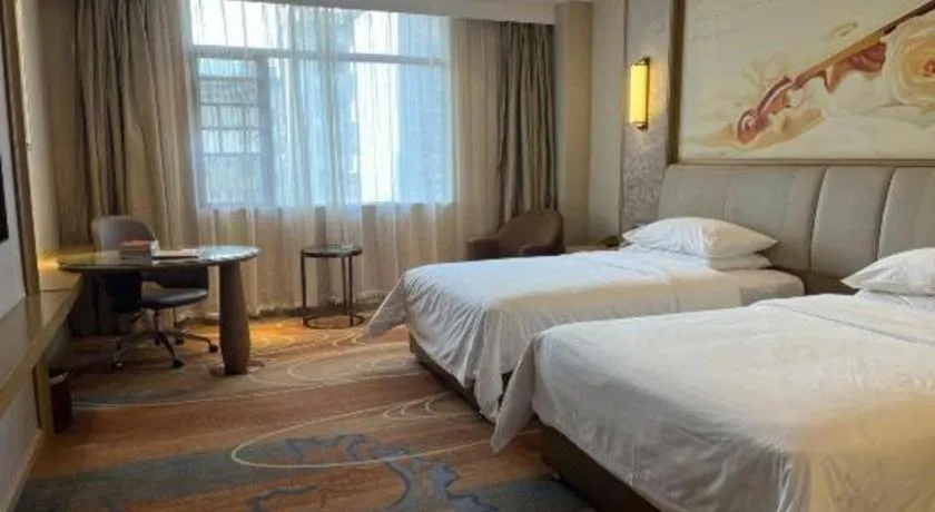 Bed in Vienna Hotel Xinfeng West High-Speed Railway Station