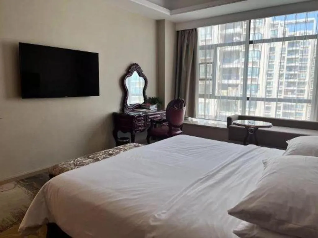 Bed in Vienna Hotel Xinfeng West High-Speed Railway Station