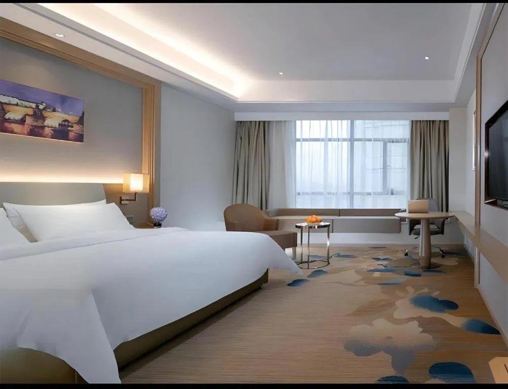 Bed in Vienna Hotel Xinfeng West High-Speed Railway Station