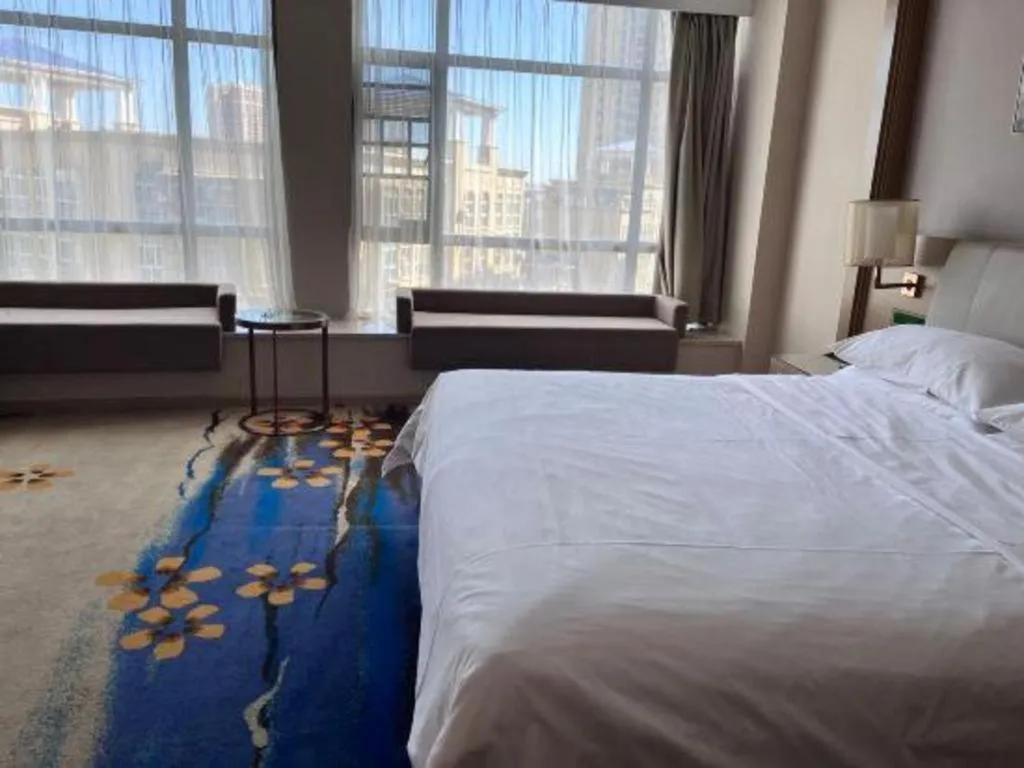Bed in Vienna Hotel Xinfeng West High-Speed Railway Station