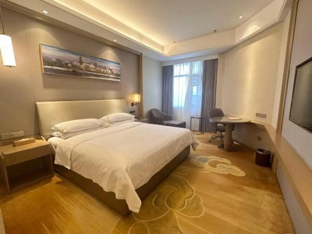 Bed in Vienna Hotel Xinfeng West High-Speed Railway Station