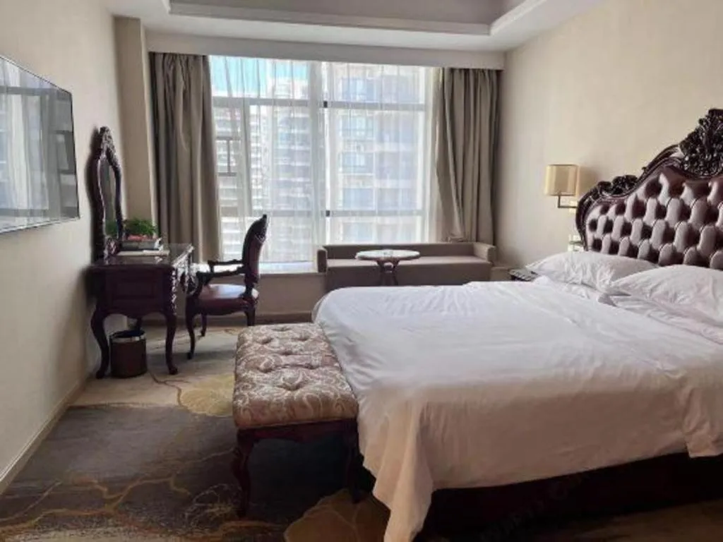 Bed in Vienna Hotel Xinfeng West High-Speed Railway Station