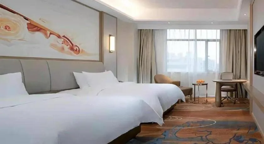 Bed in Vienna Hotel Xinfeng West High-Speed Railway Station