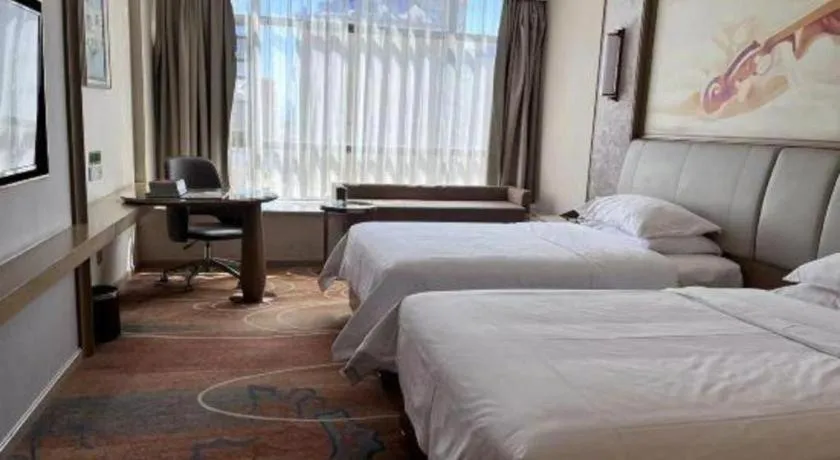 Bed in Vienna Hotel Xinfeng West High-Speed Railway Station