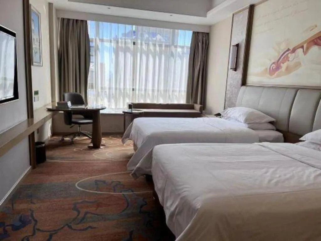 Bed in Vienna Hotel Xinfeng West High-Speed Railway Station