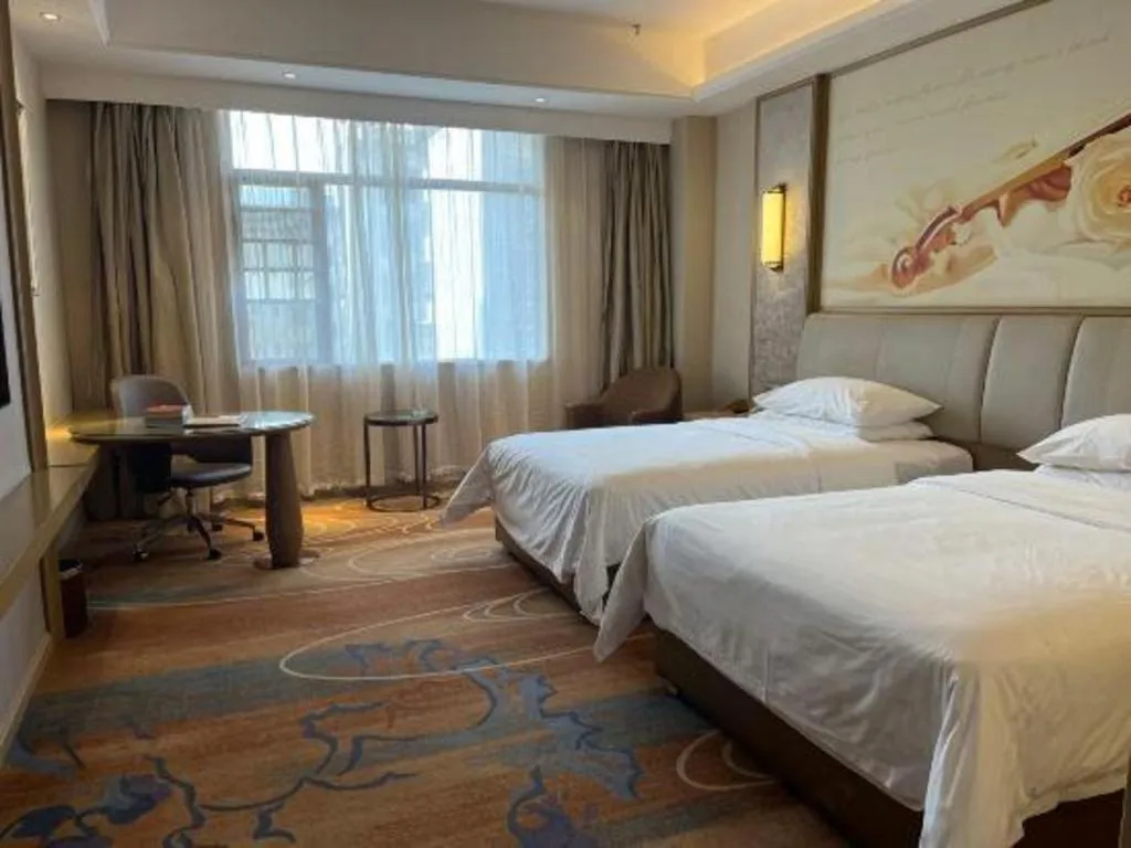 Bed in Vienna Hotel Xinfeng West High-Speed Railway Station