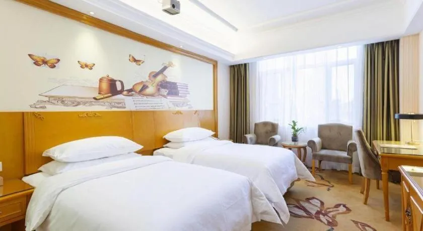 Bed in Vienna Hotel Shanxi Datong High-Speed Railway Station Wanda Plaza