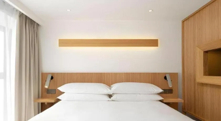 Bed in Meijin All Suites Hotel Suzhou