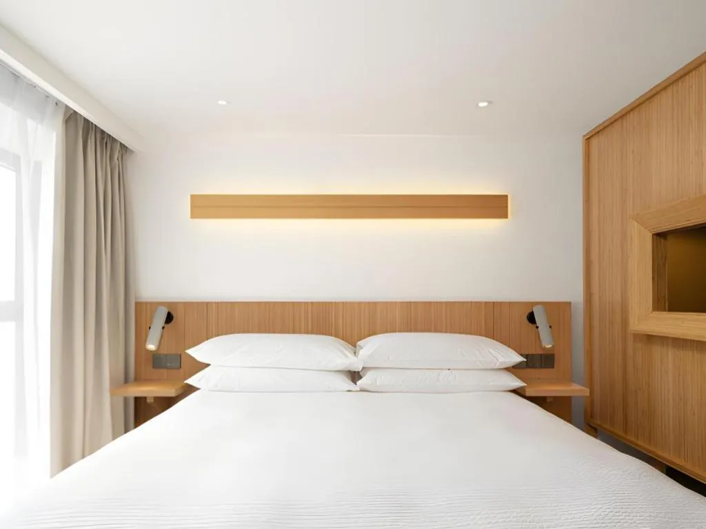 Bed in Meijin All Suites Hotel Suzhou