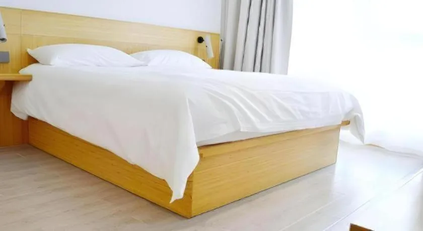 Bed in Meijin All Suites Hotel Suzhou