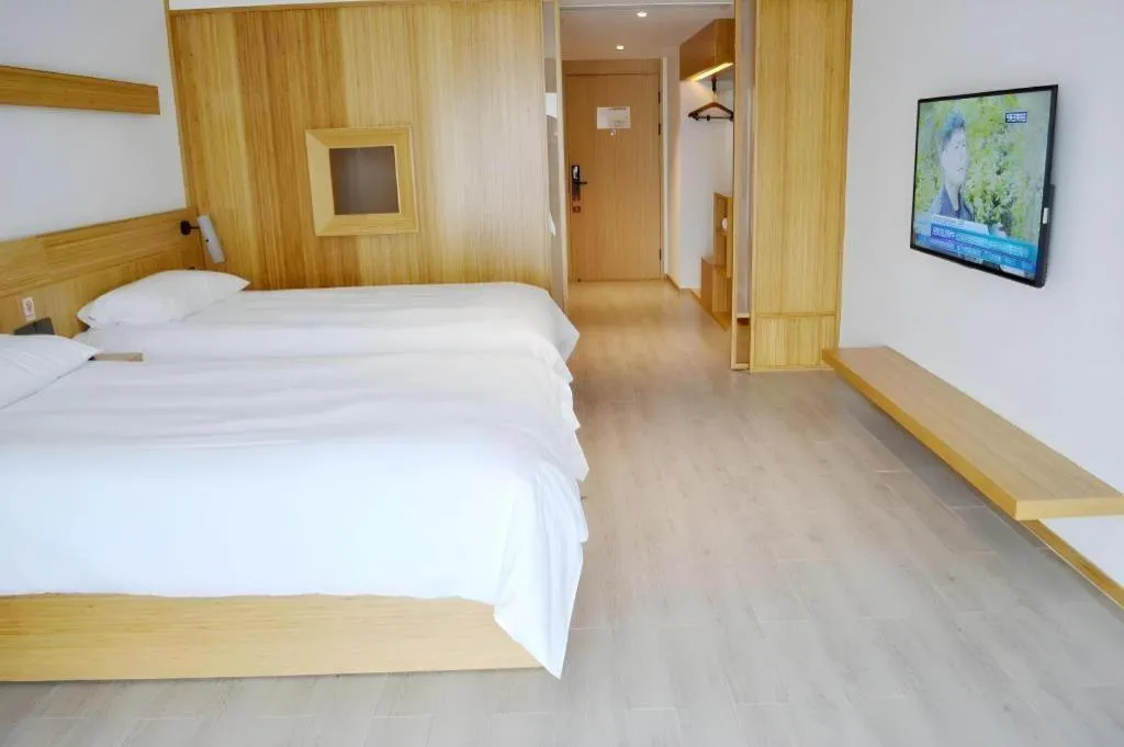 Bed in Meijin All Suites Hotel Suzhou