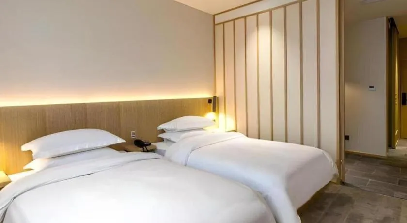Bed in Meijin All Suites Hotel Suzhou