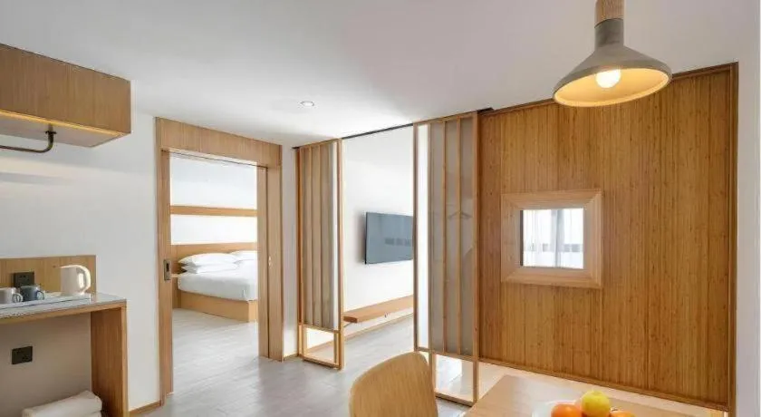 Bed in Meijin All Suites Hotel Suzhou