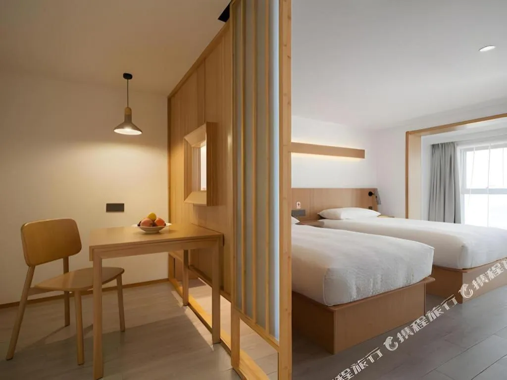 Bed in Meijin All Suites Hotel Suzhou