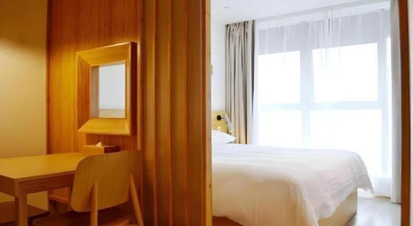 Bed in Meijin All Suites Hotel Suzhou