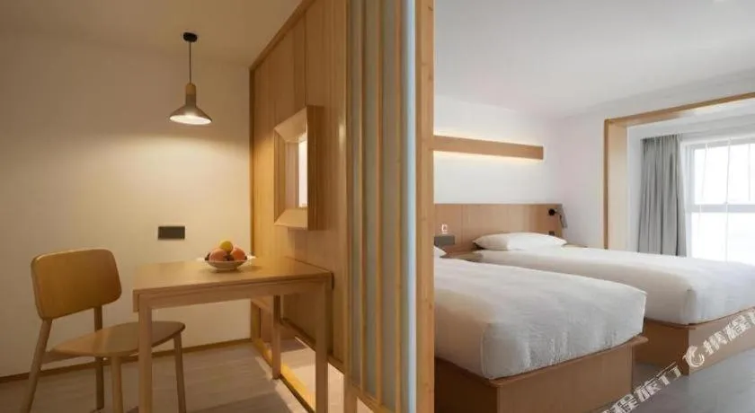 Bed in Meijin All Suites Hotel Suzhou