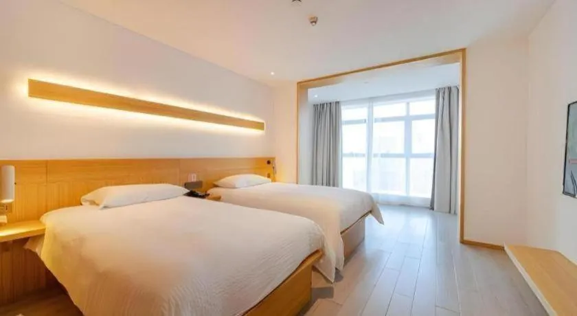 Bed in Meijin All Suites Hotel Suzhou