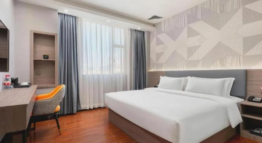 Bed in Borrman Hotel Huizhou Danshui High-speed Railway Huiyang Station