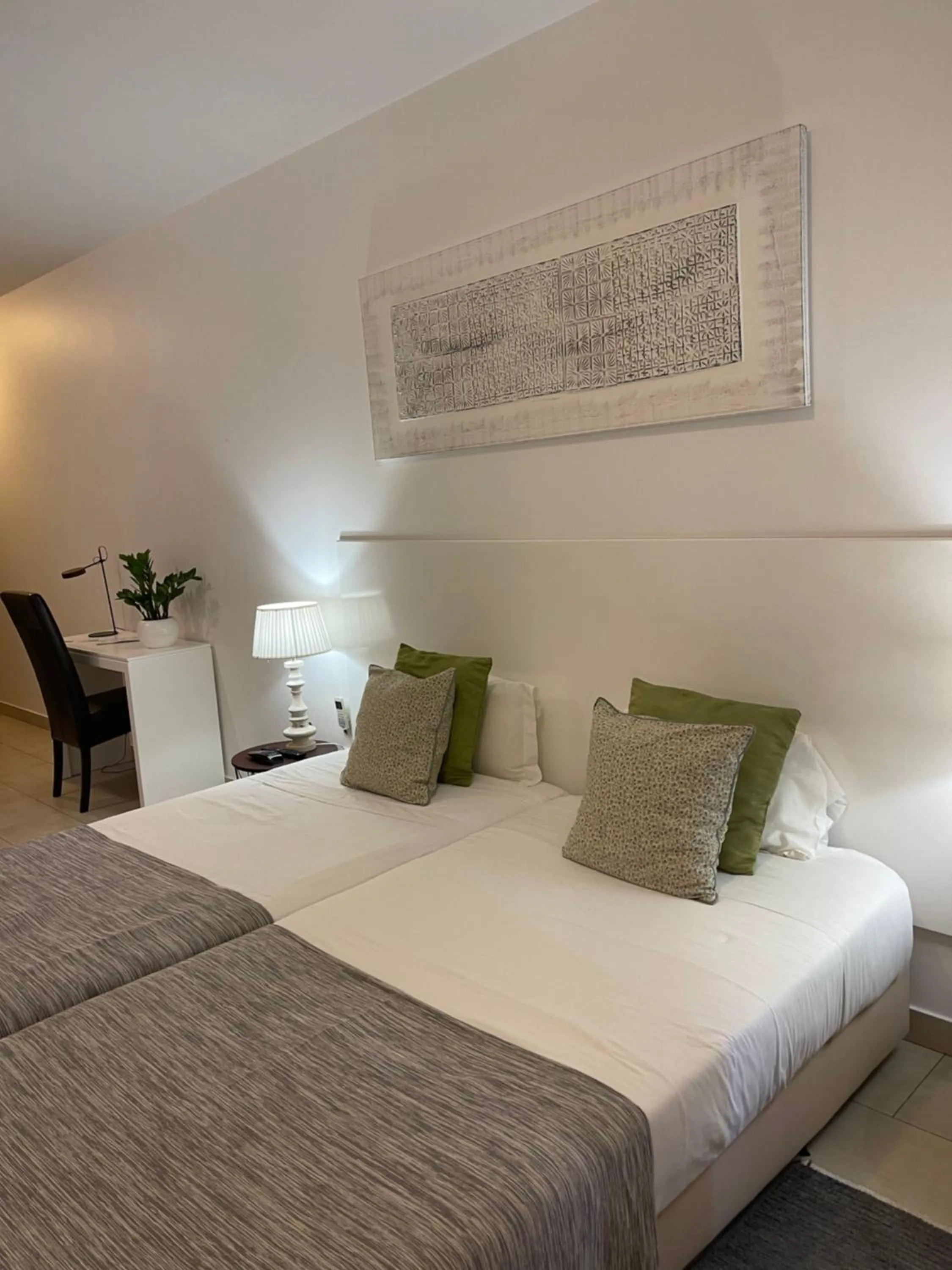 Bed in Esmeralda Holidays Apartments