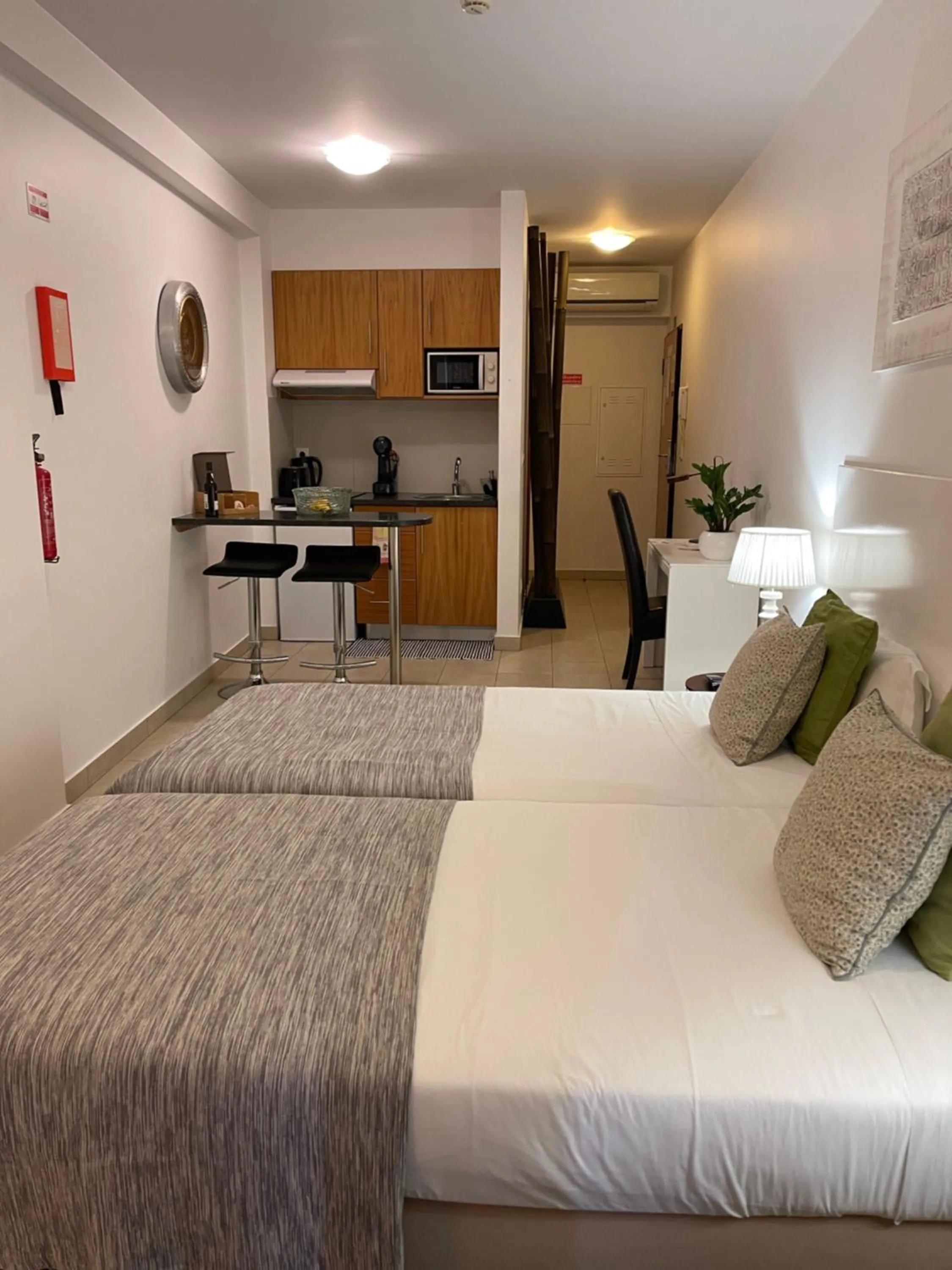 Bed in Esmeralda Holidays Apartments