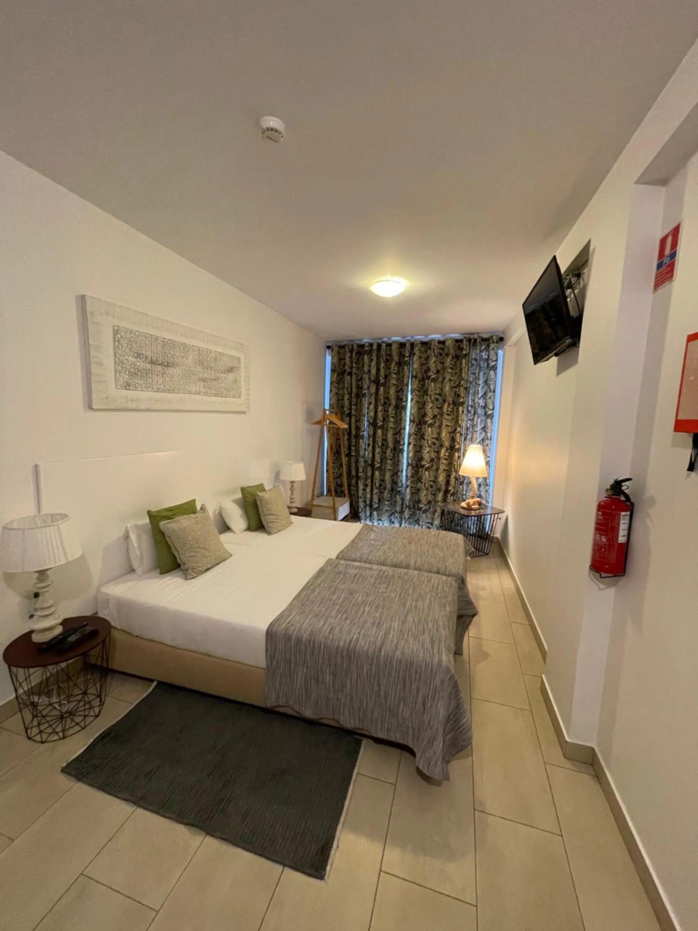 Bed in Esmeralda Holidays Apartments