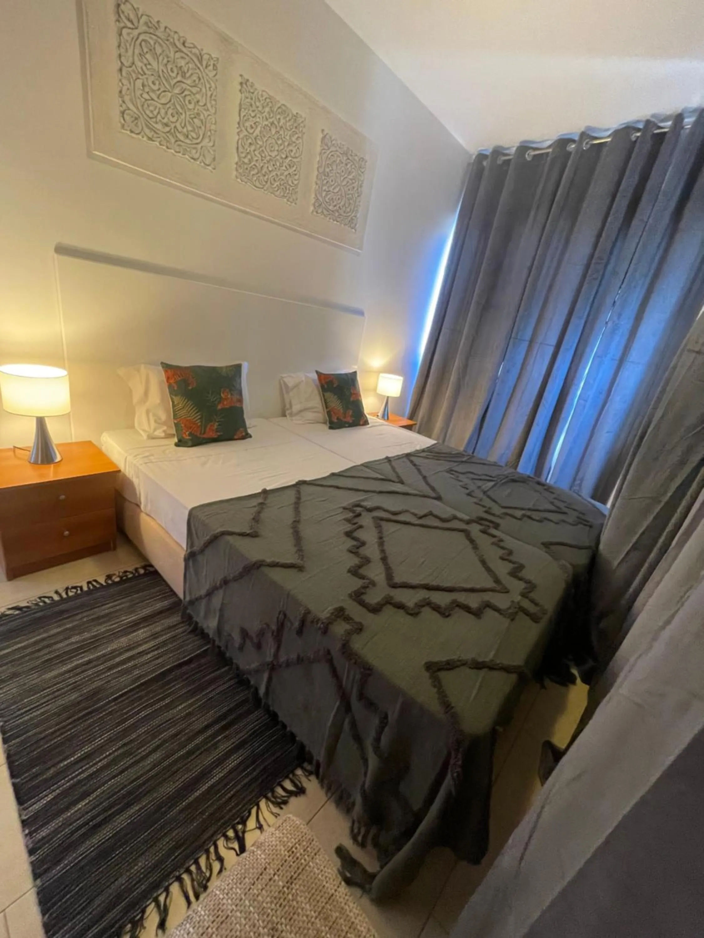 Bed in Esmeralda Holidays Apartments