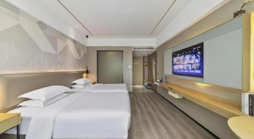 Bed in Borrman Hotel Wanning Wenming Road High-speed Railway Station