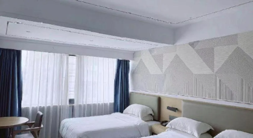 Bed in Borrman Hotel Wanning Wenming Road High-speed Railway Station