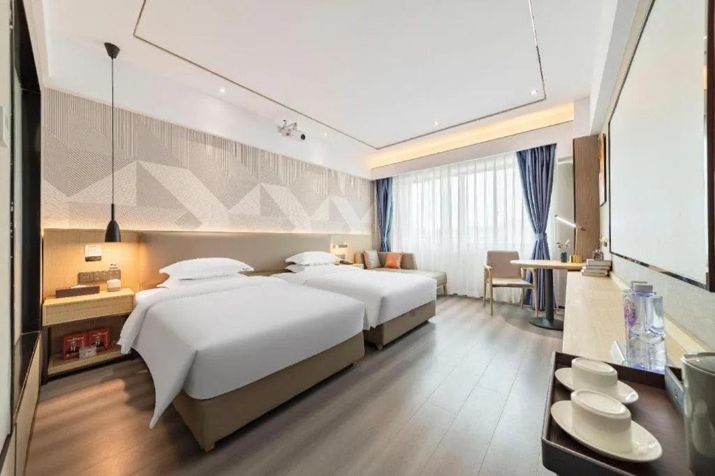 Bed in Borrman Hotel Wanning Wenming Road High-speed Railway Station