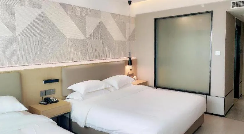 Bed in Borrman Hotel Wanning Wenming Road High-speed Railway Station