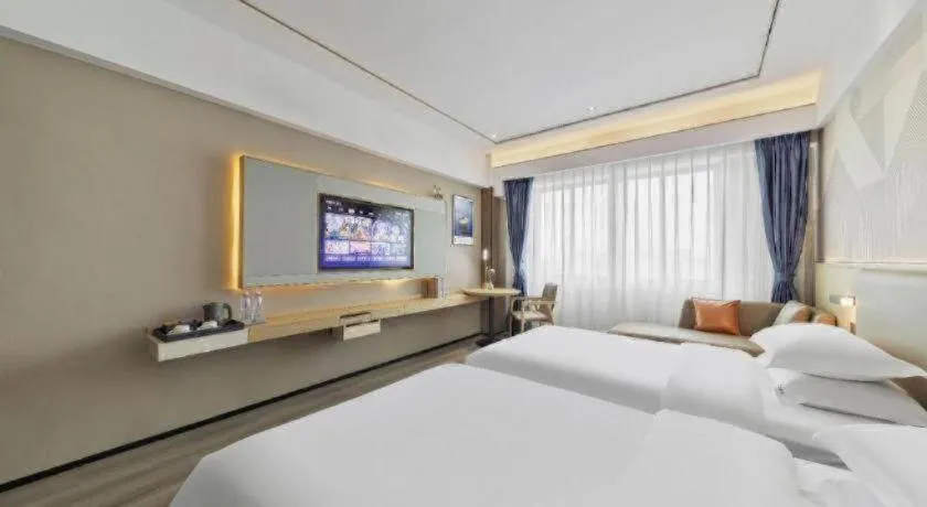 Bed in Borrman Hotel Wanning Wenming Road High-speed Railway Station