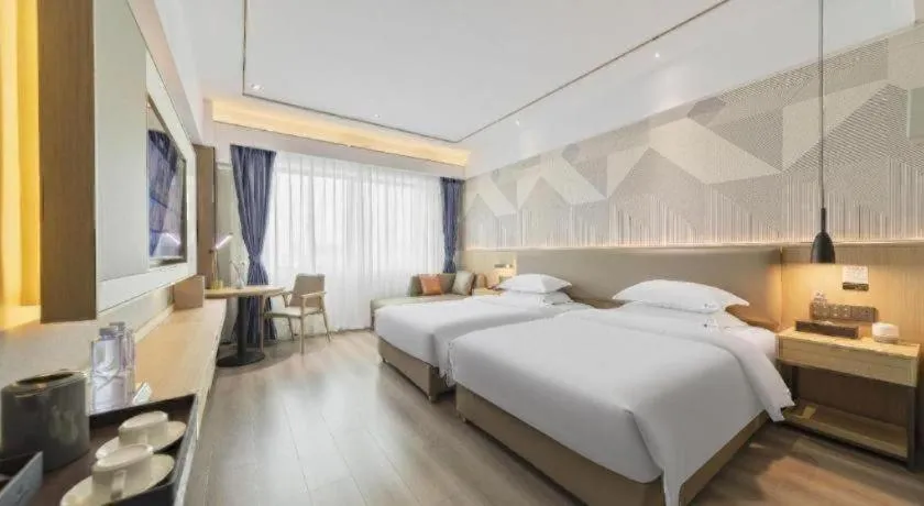 Bed in Borrman Hotel Wanning Wenming Road High-speed Railway Station