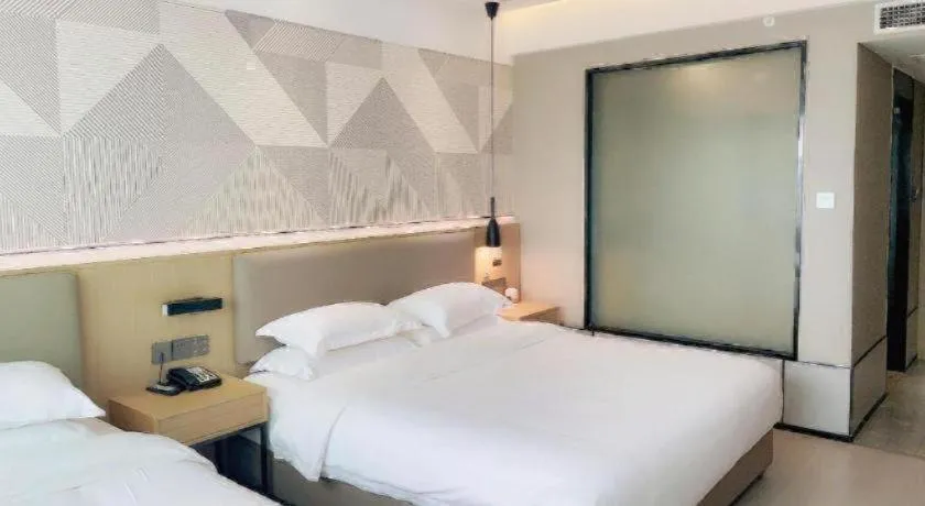 Bed in Borrman Hotel Wanning Wenming Road High-speed Railway Station