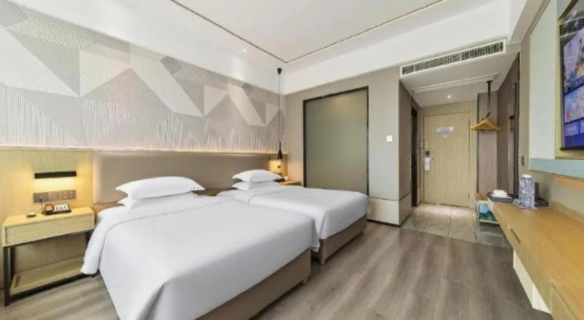 Bed in Borrman Hotel Wanning Wenming Road High-speed Railway Station