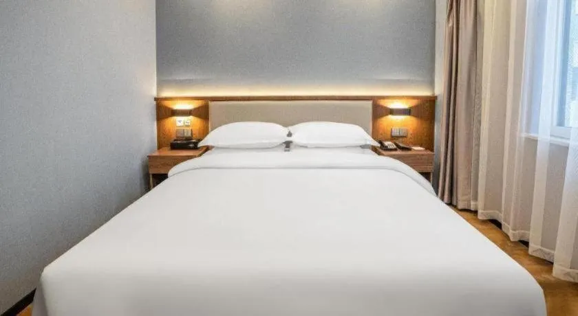 Bed in Borrman Hotel Zoucheng Huamaowan Mall