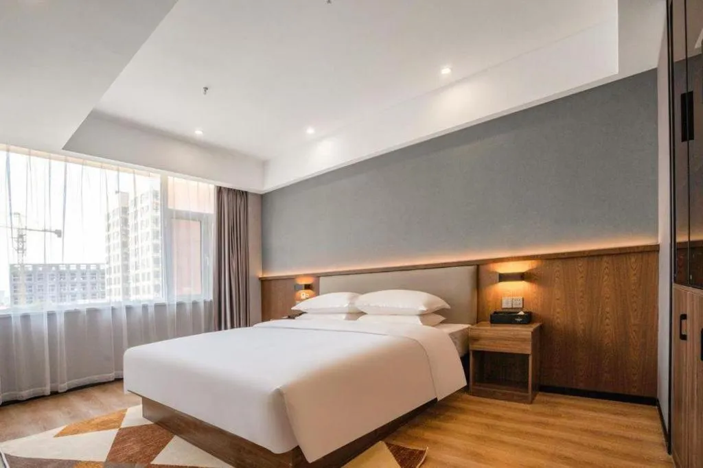 Bed in Borrman Hotel Zoucheng Huamaowan Mall