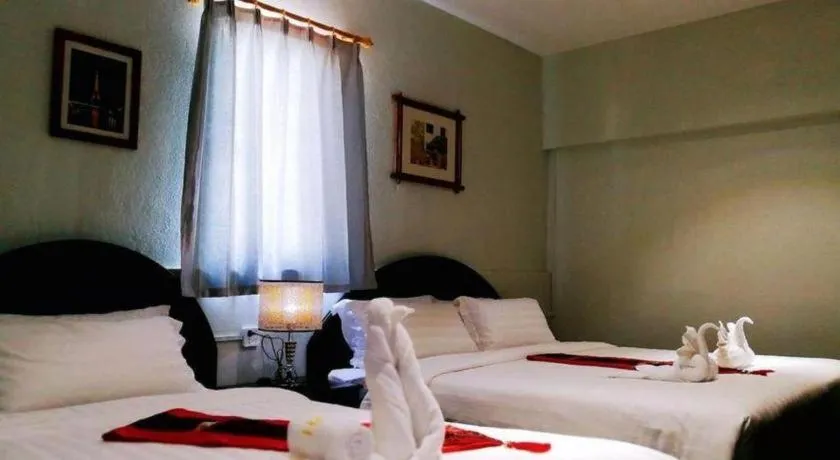 Bed in New Lao Paris Hotel